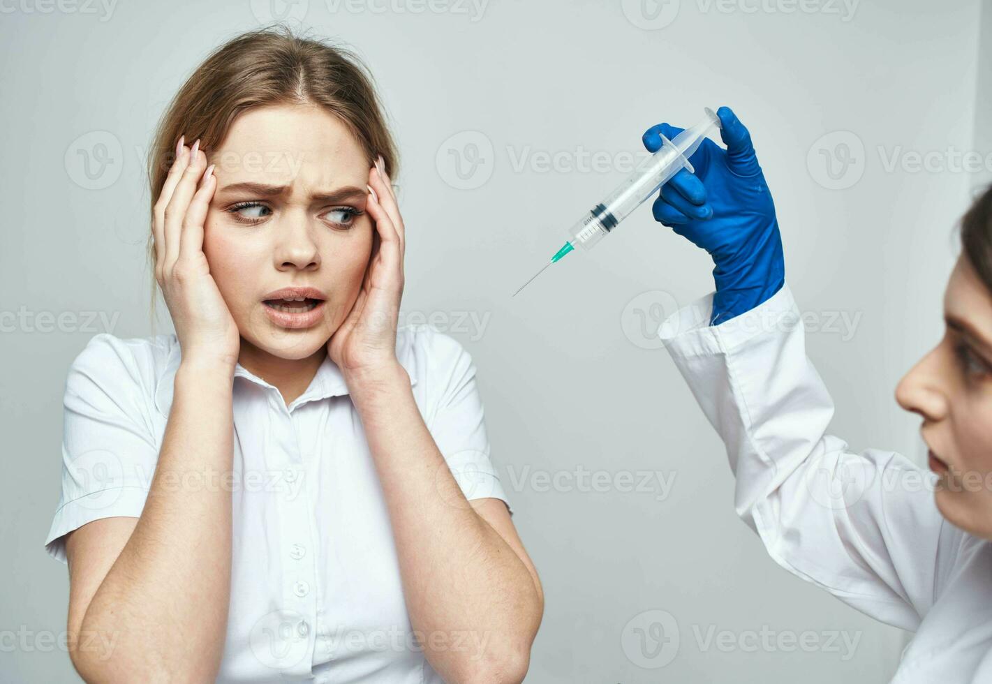 doctor blue gloves and woman syringe anesthesia botox injection photo