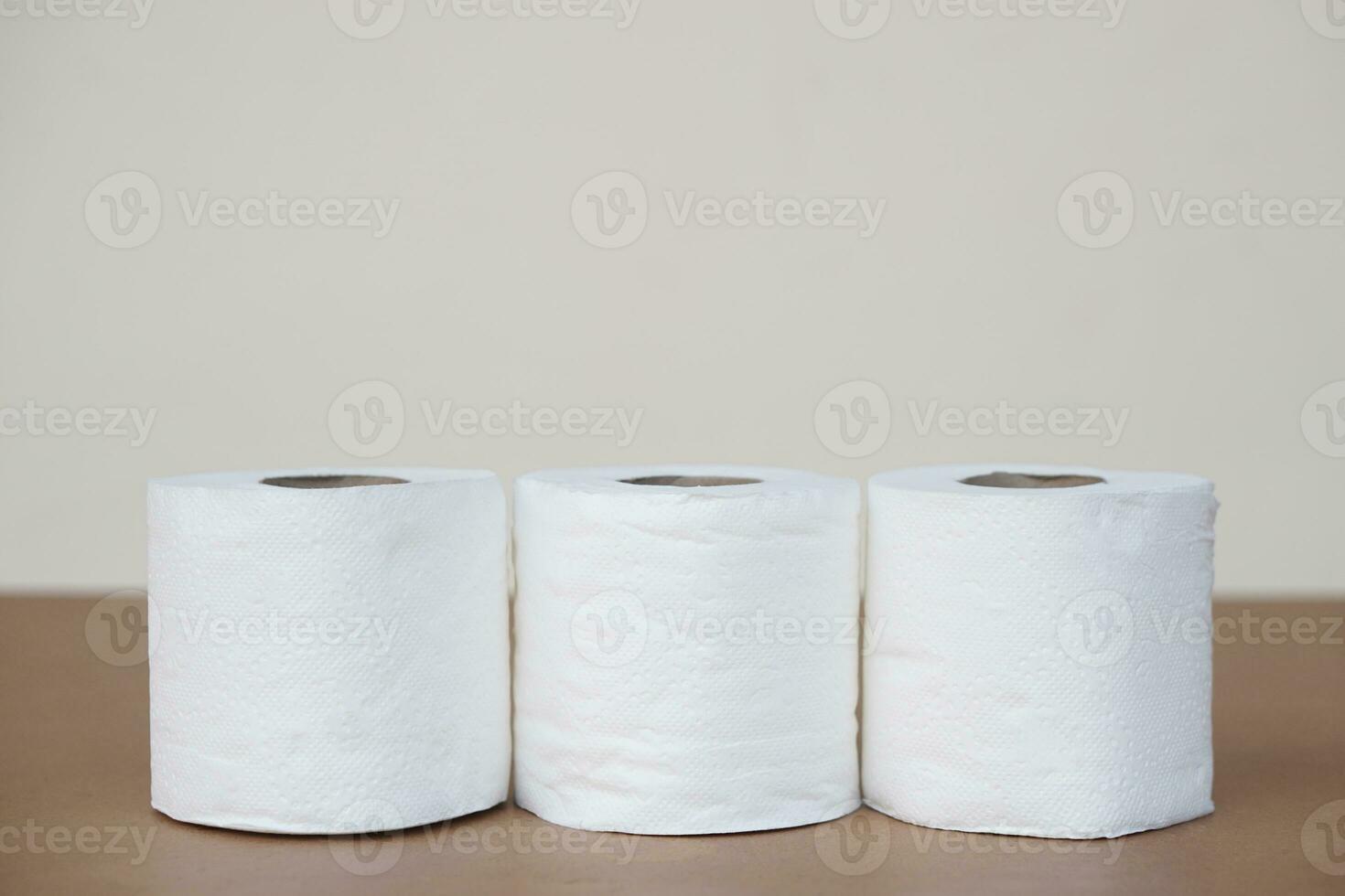 Three rolls of soft white toilet tissue paper. Concept, hygienic and sanitary materials for after using toilet or bathroom. Useful and versatile for cleaning and wiping. photo