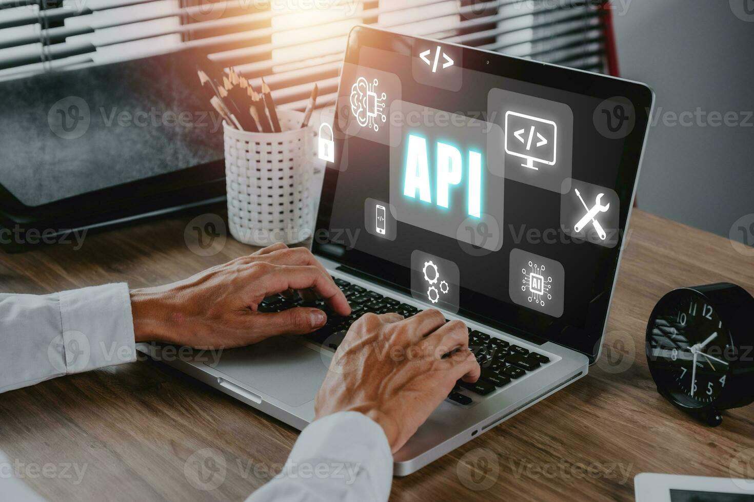 API - Application Programming Interface, Man using laptop computer with touch screen interface and select API icon, Software development tool, modern technology, internet and networking concept. photo