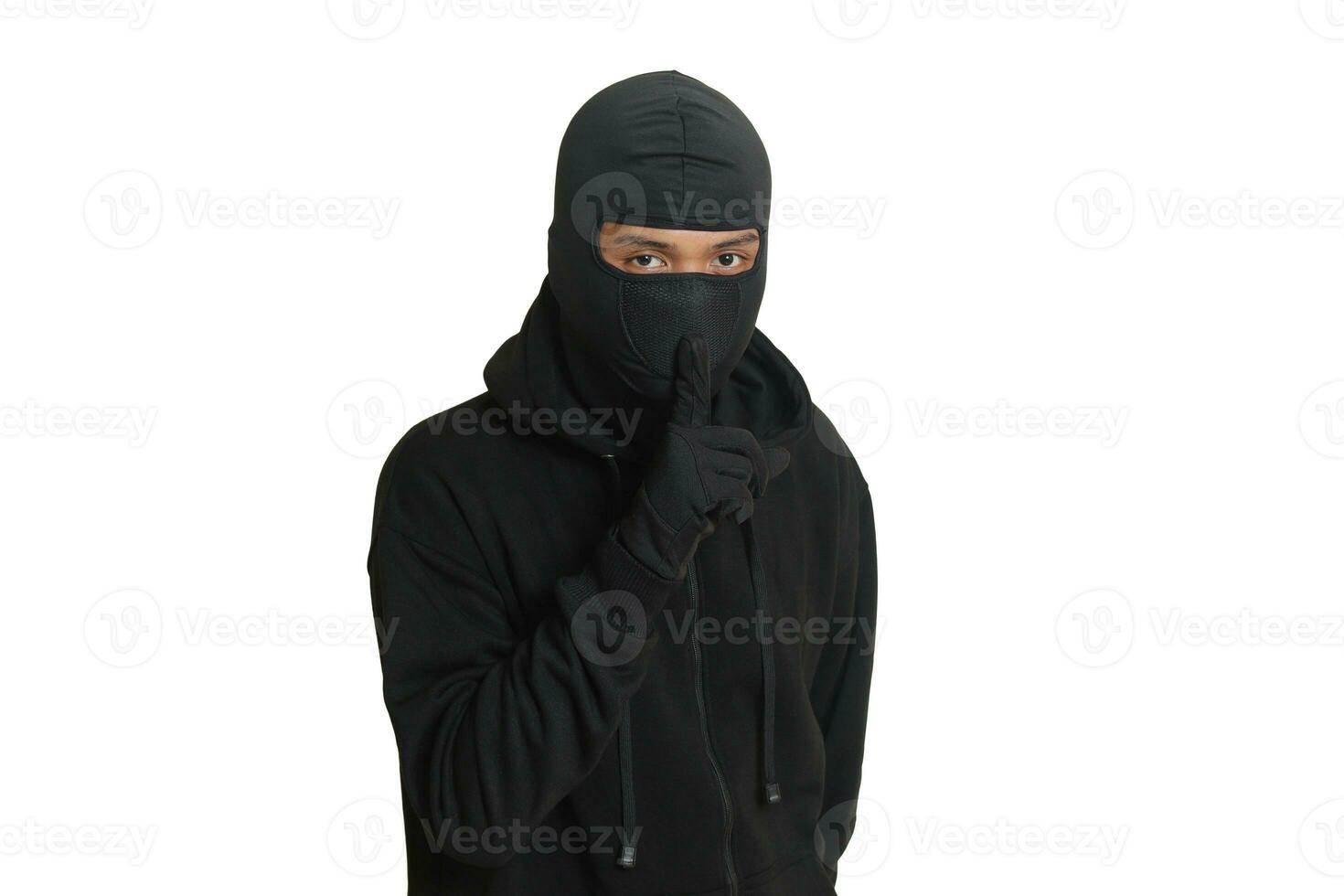 Mysterious man wearing black hoodie standing and looking at camera. Isolated image on gray background photo