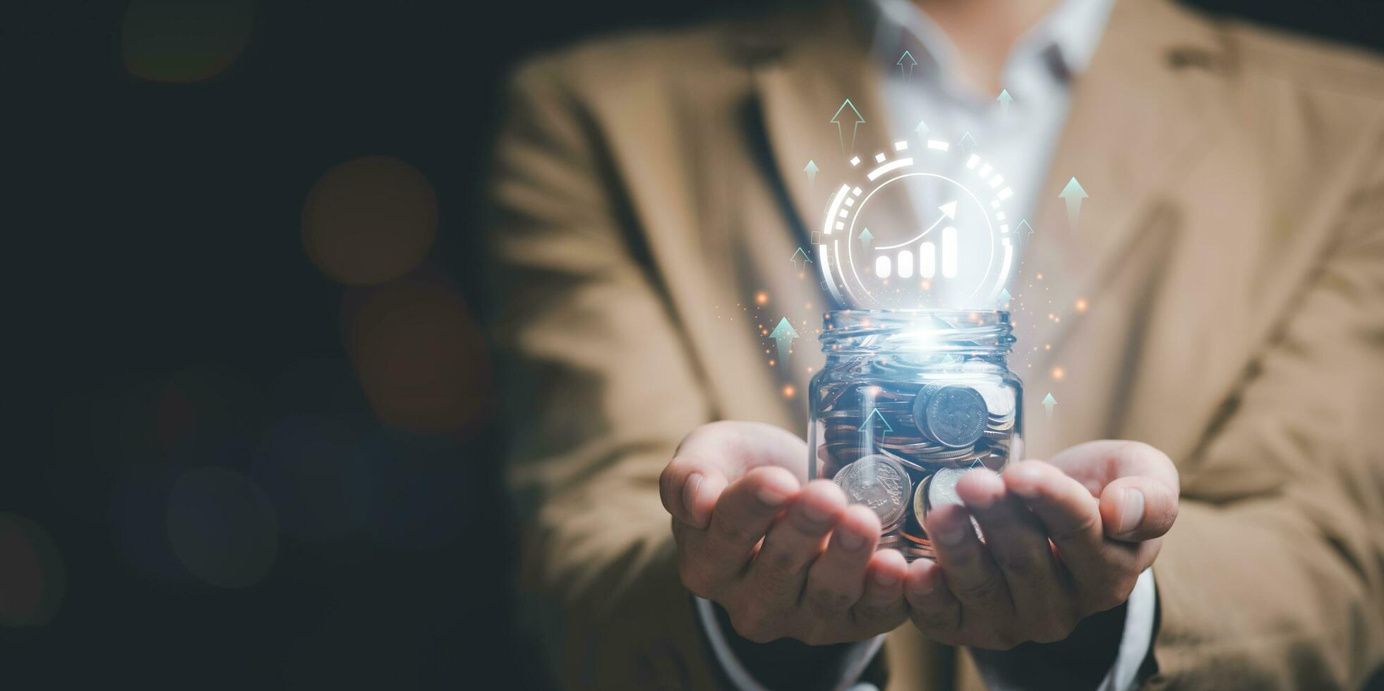 Man holding a jar of money coins and showing money growth concept ,financial concept and saving money , investment savings ,Planning savings for the future ,retirement fund ,future risk management photo