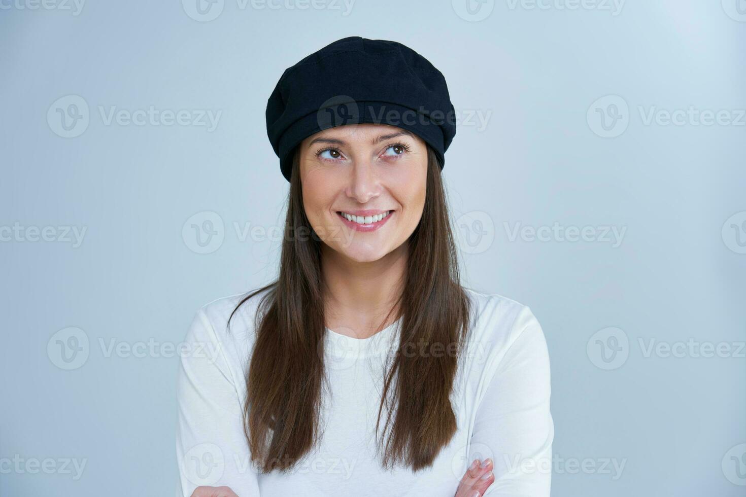 Isolated picture of brunette woman on white background wearing hat photo