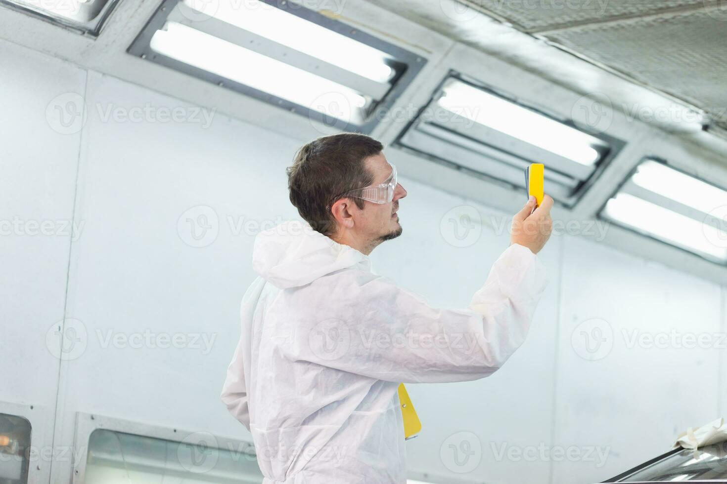 Repairman checking shades cards for car painting, Worker painter checking color matching before painting, Garage painting car service repair and maintenance photo
