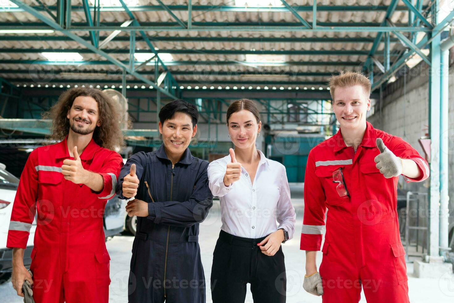 Portrait of a young confident managers and car mechanic team showing thumbs up in repair garage, Car repair and maintenance concepts photo