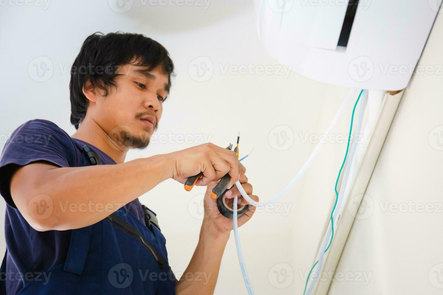 Technician man installing air conditioning in a client house