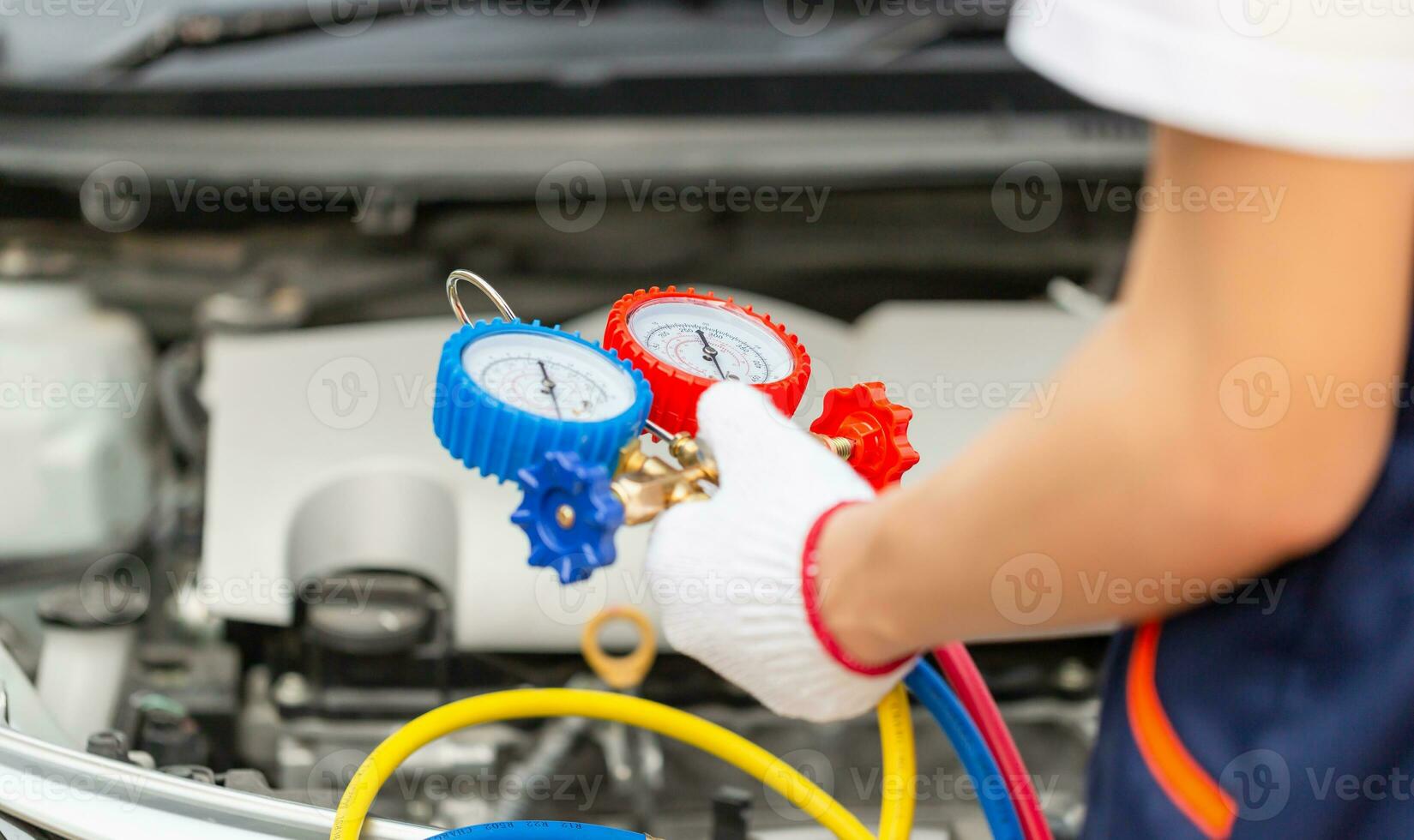 Technician man check car air conditioning system refrigerant recharge, Repairman holding monitor tool to check and fixed car air conditioner system, Air Conditioning Repair photo