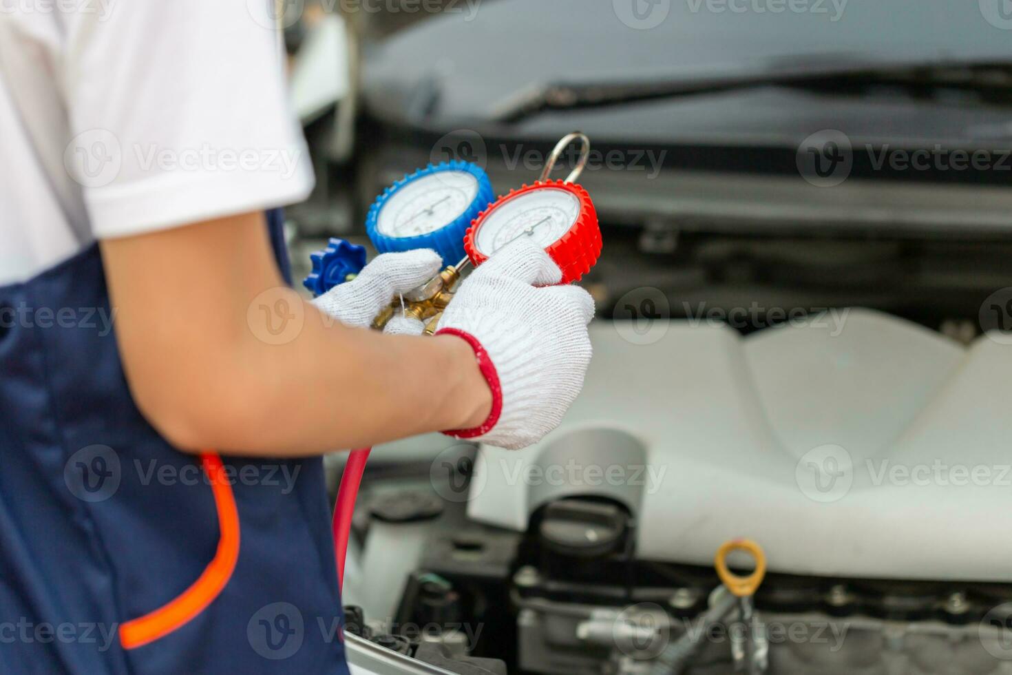 Technician check car air conditioning system refrigerant recharge, Repairman holding monitor tool to check and fixed car air conditioner system, Air Conditioning Repair photo