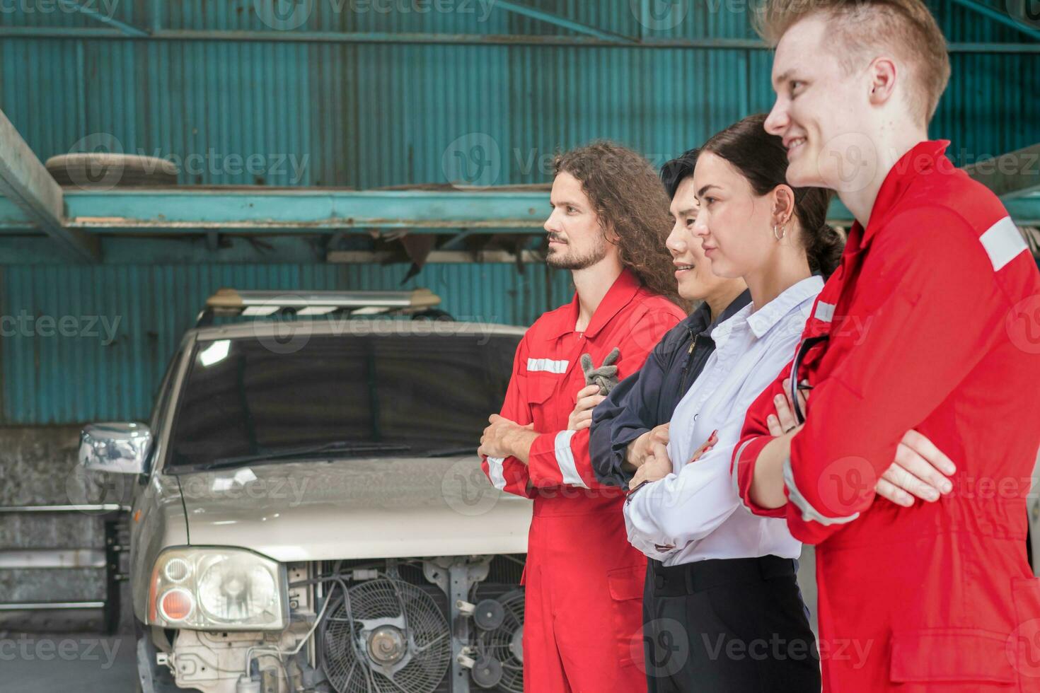 Portrait of confident managers and auto mechanic team standing with arms crossed in a repair garage, Car repair and maintenance concepts photo