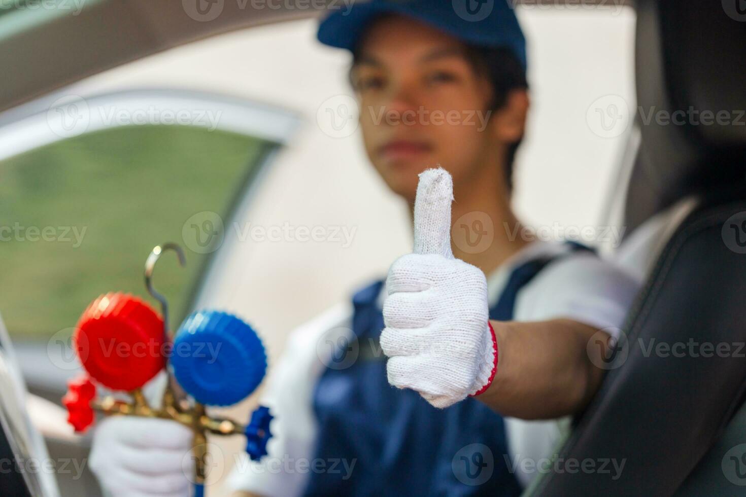 Technician showing thumbs up and holding monitor tool to check and fixed car air conditioner system, Repairman check car air conditioning system, Air Conditioning Repair photo