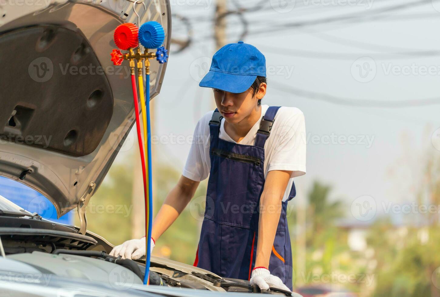 Technician man check car air conditioning system refrigerant recharge, Repairman with monitor tool to check and fixed car air conditioner system, Air Conditioning Repair photo