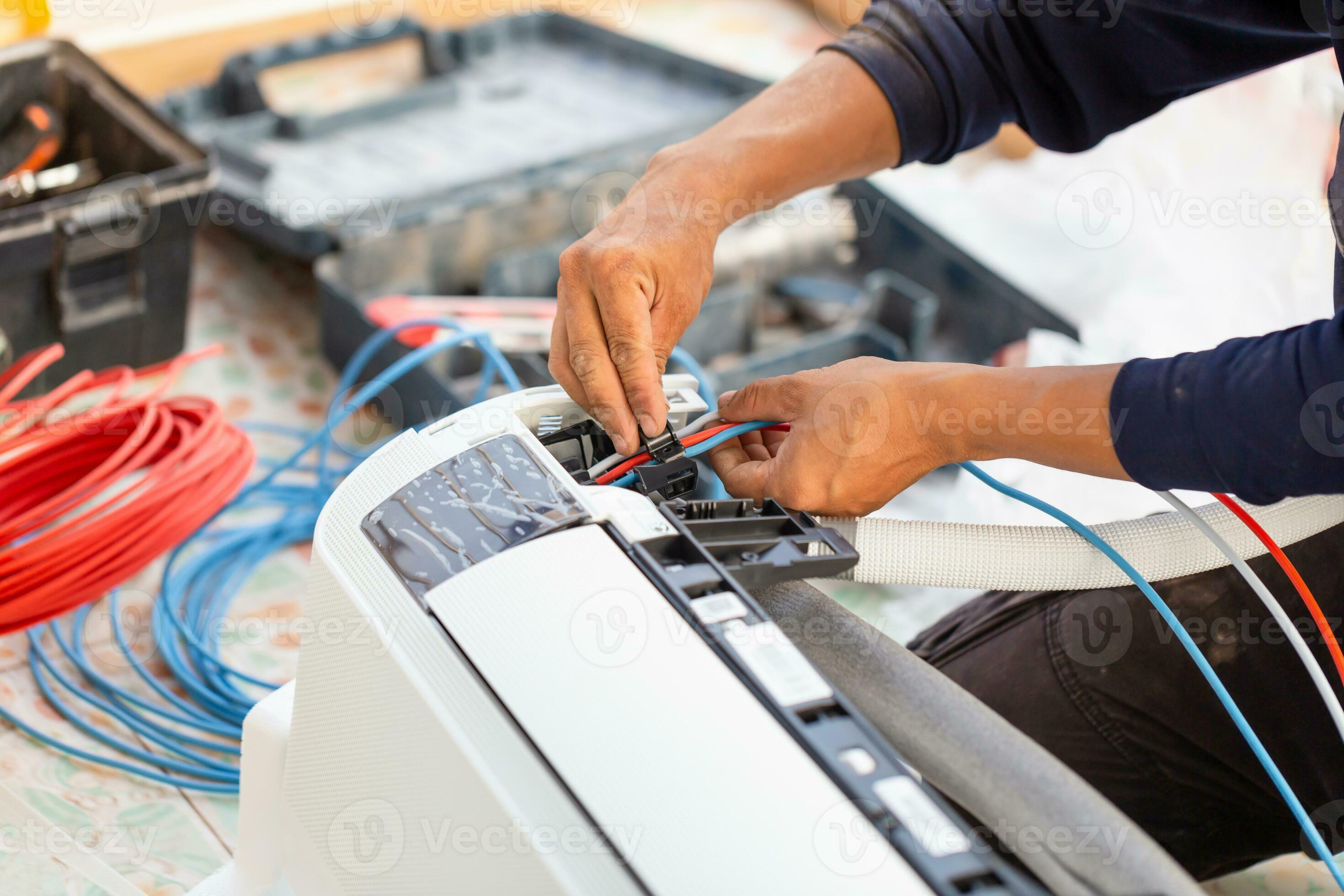 Technician man installing air conditioning in a client house