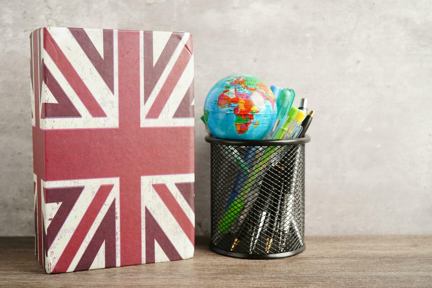 Bangkok, Thailand April 1, 2023 English book and piggy bank with globe, learning and tutorial for foreigner photo