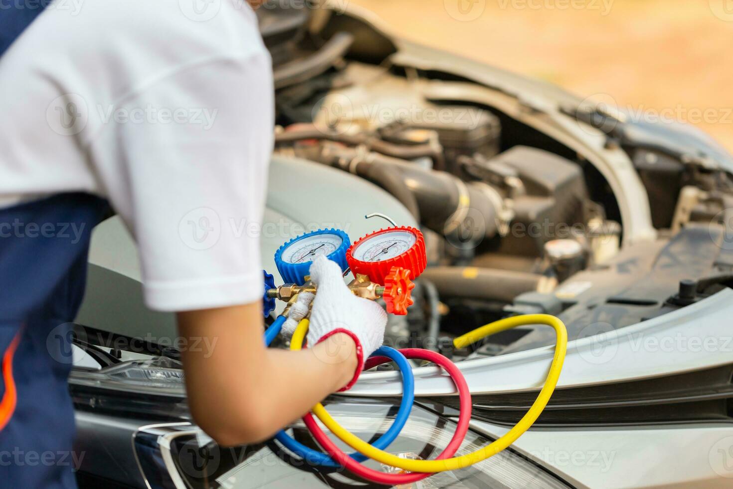 Repairman holding monitor tool to check and fixed car air conditioner system, Technician man check car air conditioning system refrigerant recharge, Air Conditioning Repair photo