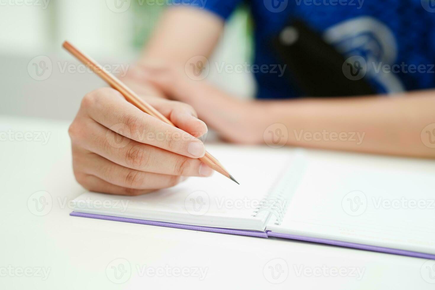 Asian teenage student write homework, study lesson for exam online learning education. photo