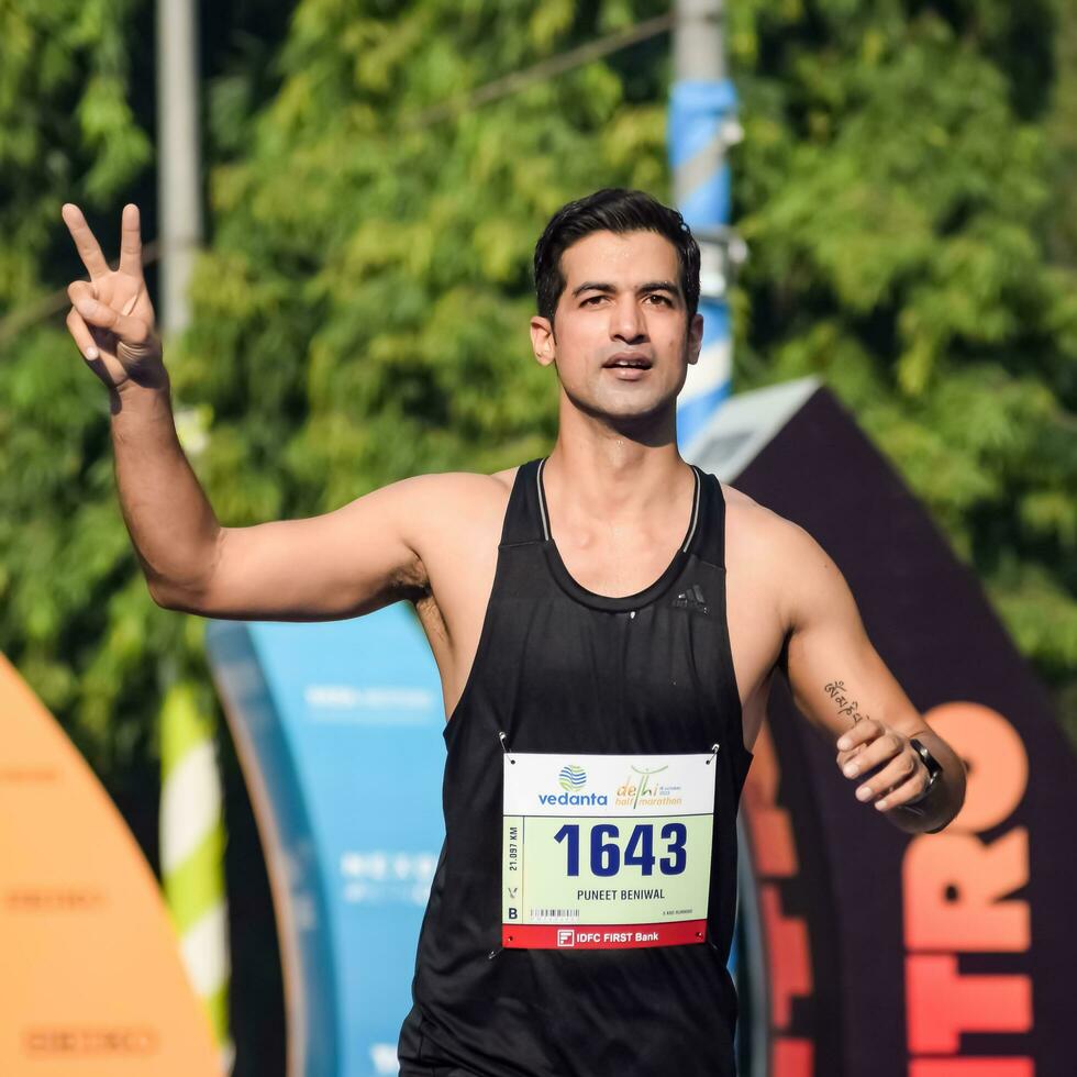 nuevo Delhi, India - abril dieciséis 2023 - vedanta Delhi medio maratón carrera después codicioso en cuales maratón Participantes acerca de a cruzar el terminar línea, Delhi medio maratón 2022 foto