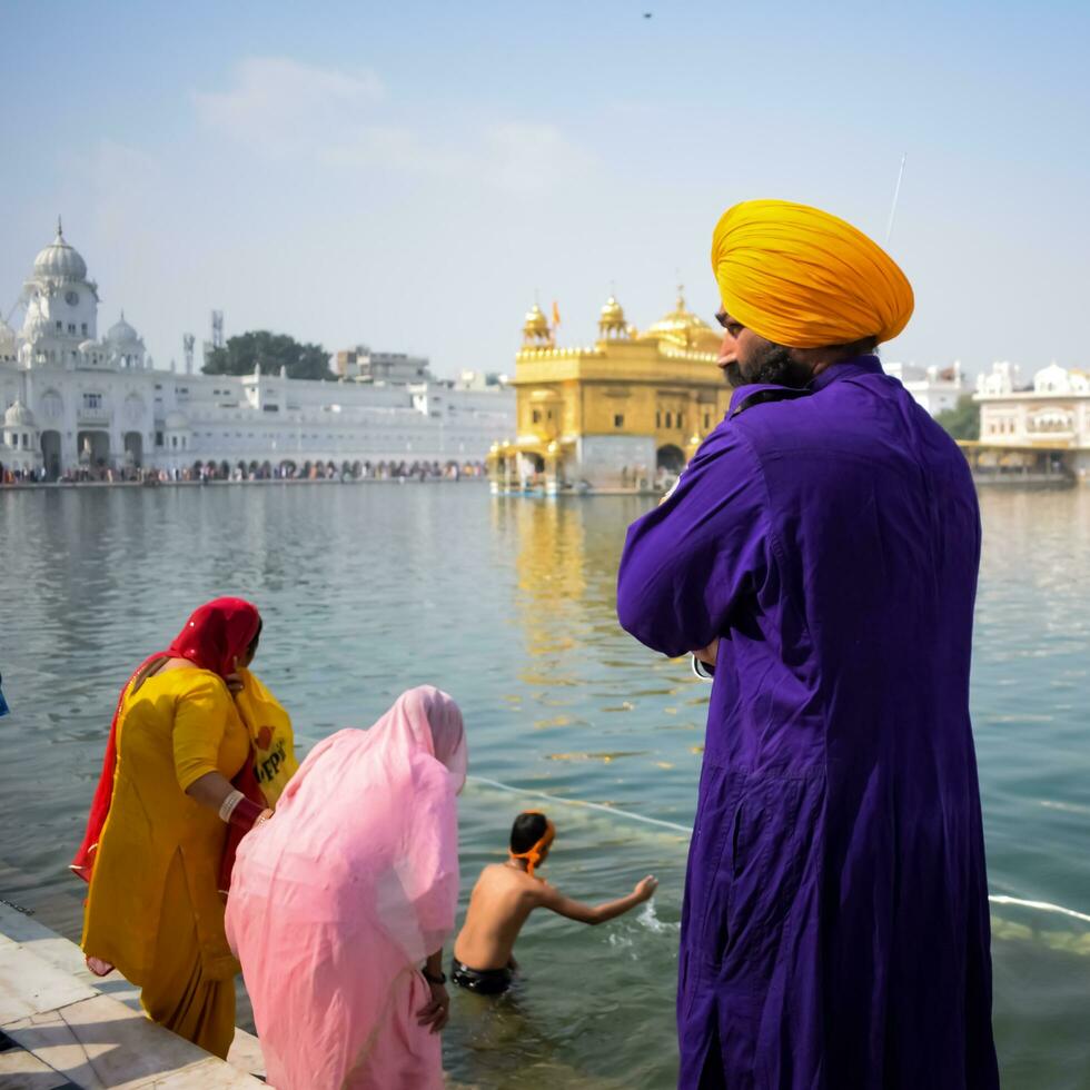 Amritsar, India - February 26 2023 - Unidentified devotees from various parts at Golden Temple - Harmandir Sahib in Amritsar, Punjab, India, Famous indian sikh landmark, Golden Temple photo