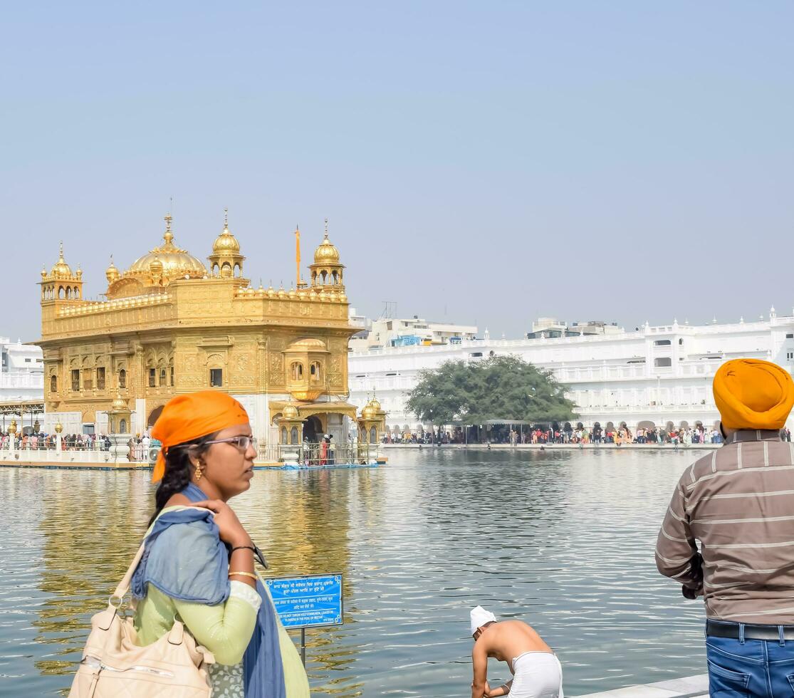 Amritsar, India - February 26 2023 - Unidentified devotees from various parts at Golden Temple - Harmandir Sahib in Amritsar, Punjab, India, Famous indian sikh landmark, Golden Temple photo