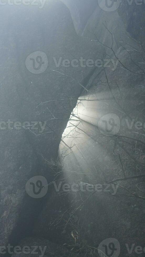 The beautiful mountains view surrounded by the misty fog in winter photo