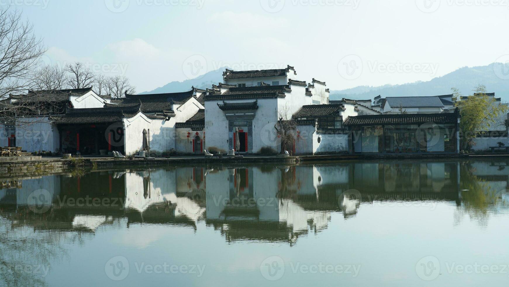 One old traditional Chinese village view with the old arched stone bridge and old wooden buildings in the Southern countryside of the China photo