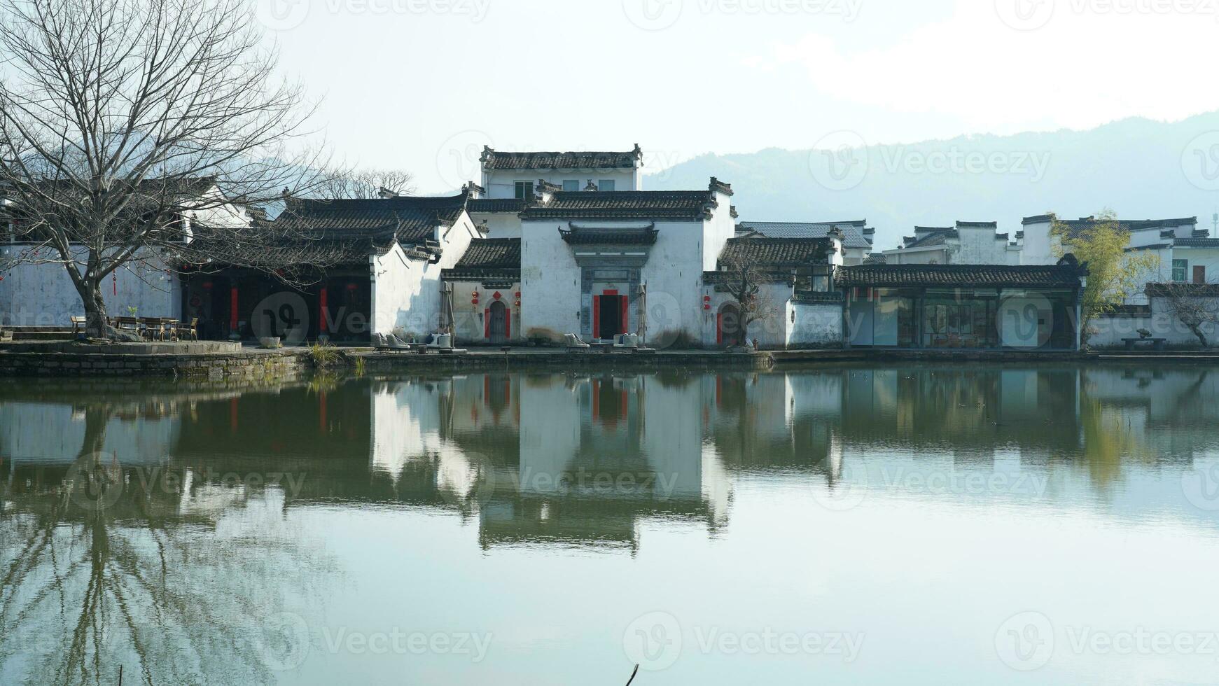 One old traditional Chinese village view with the old arched stone bridge and old wooden buildings in the Southern countryside of the China photo