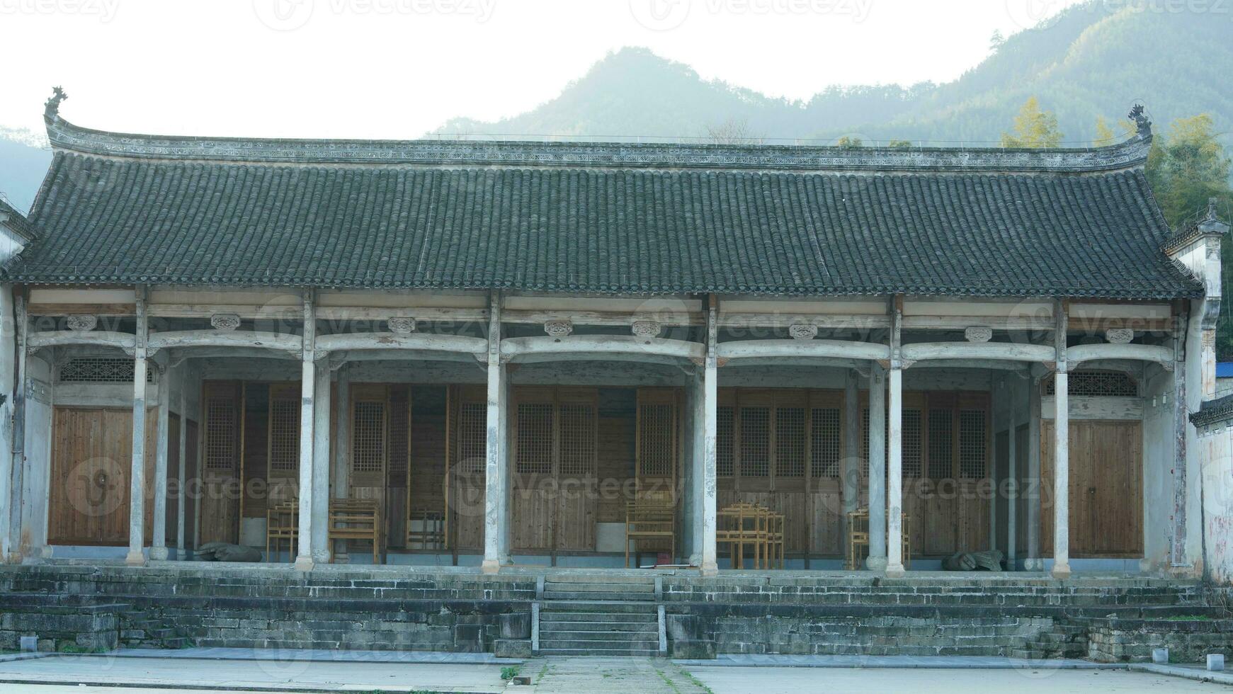 The beautiful traditional Chinese village view with the classical architecture and fresh green trees as background photo
