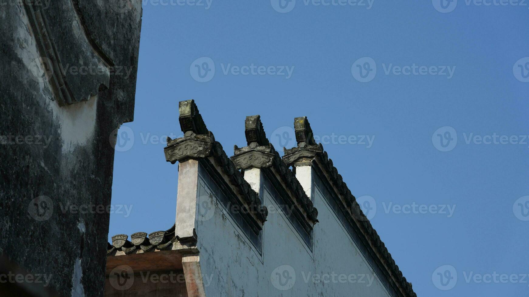 The beautiful traditional Chinese village view with the classical architecture and fresh green trees as background photo