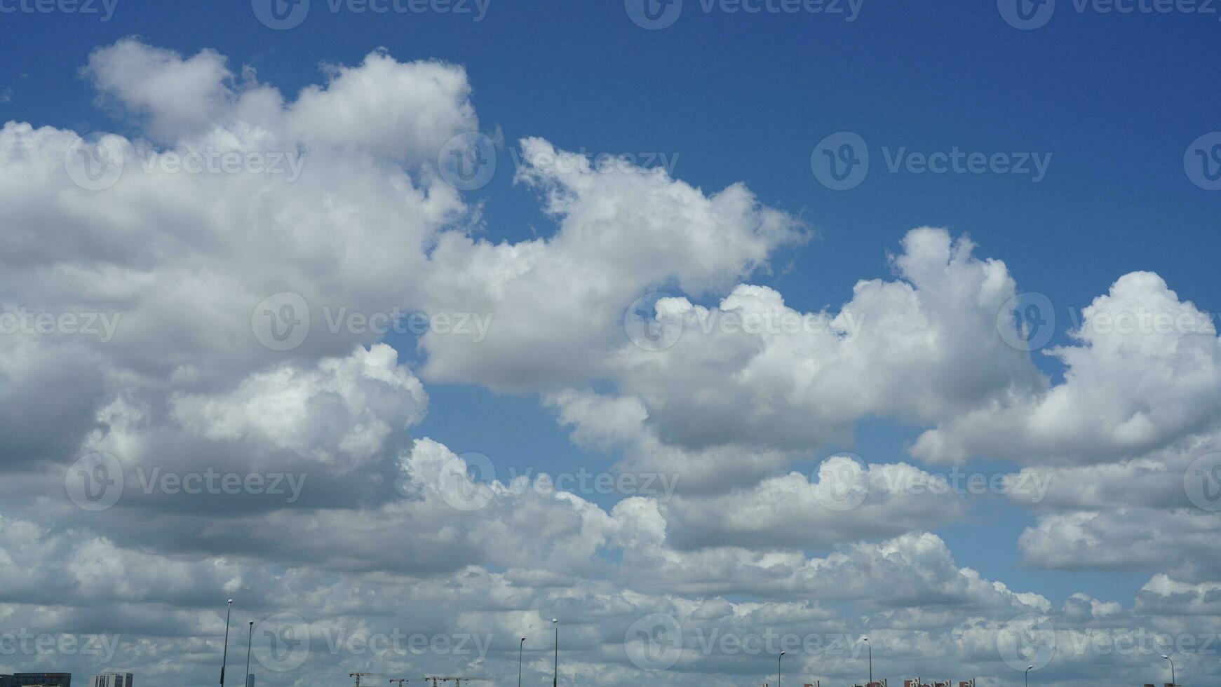 The beautiful sky view with the white clouds and blue sky as background in summer photo