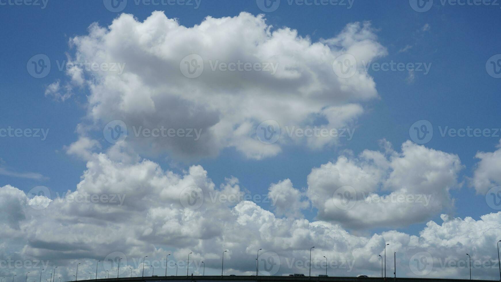 The beautiful sky view with the white clouds and blue sky as background in summer photo