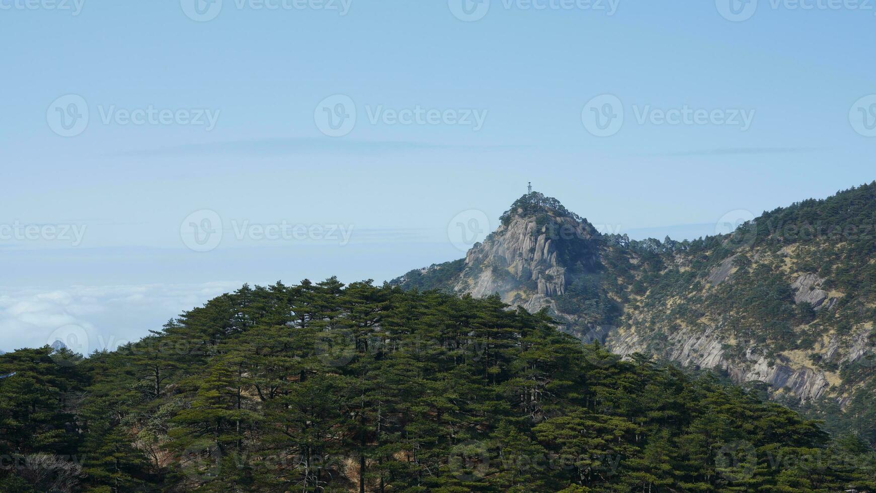 The beautiful mountains view surrounded by the misty fog in winter photo