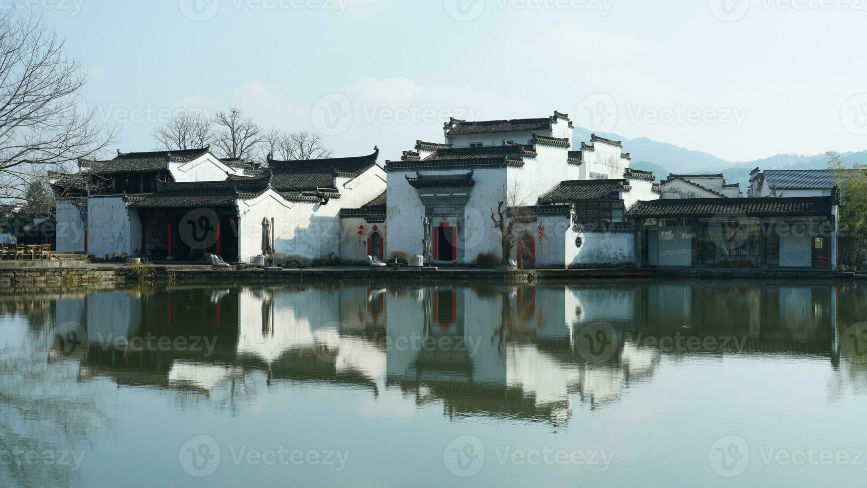 One old traditional Chinese village view with the old arched stone bridge and old wooden buildings in the Southern countryside of the China photo