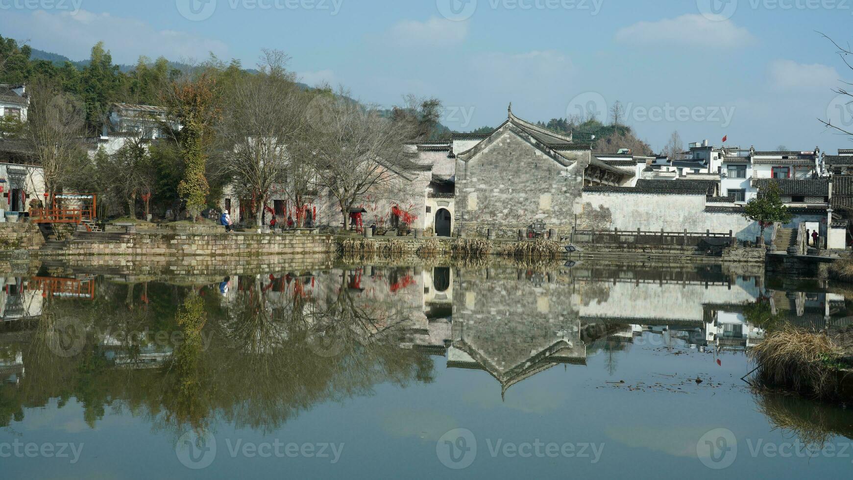 One old traditional Chinese village view with the old arched stone bridge and old wooden buildings in the Southern countryside of the China photo