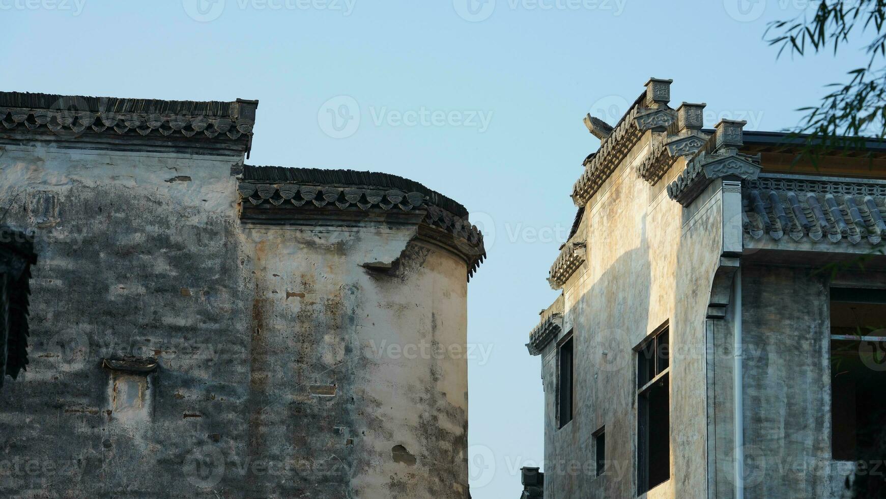 The beautiful traditional Chinese village view with the classical architecture and fresh green trees as background photo