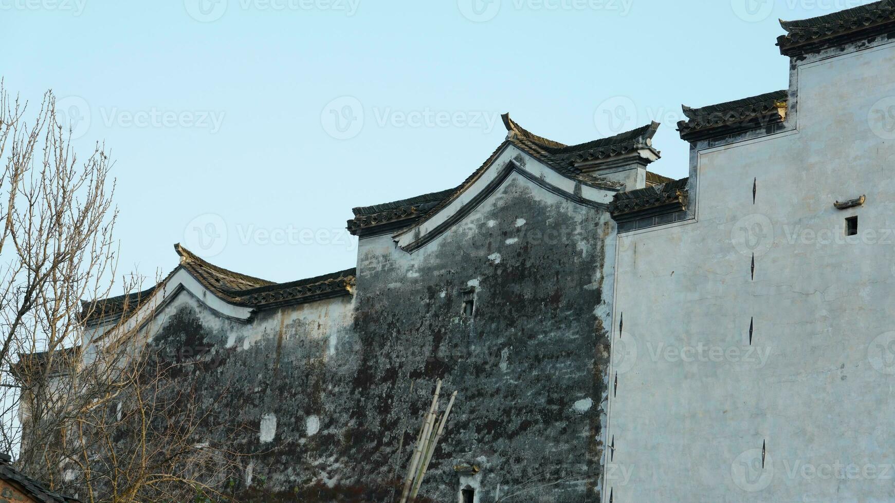 The beautiful traditional Chinese village view with the classical architecture and fresh green trees as background photo