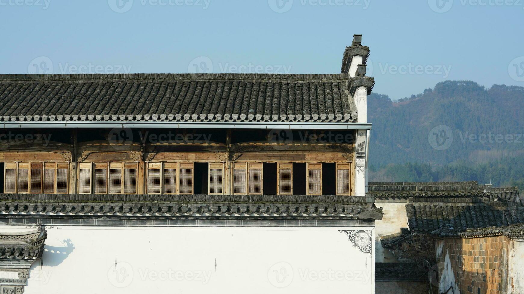 The beautiful traditional Chinese village view with the classical architecture and fresh green trees as background photo