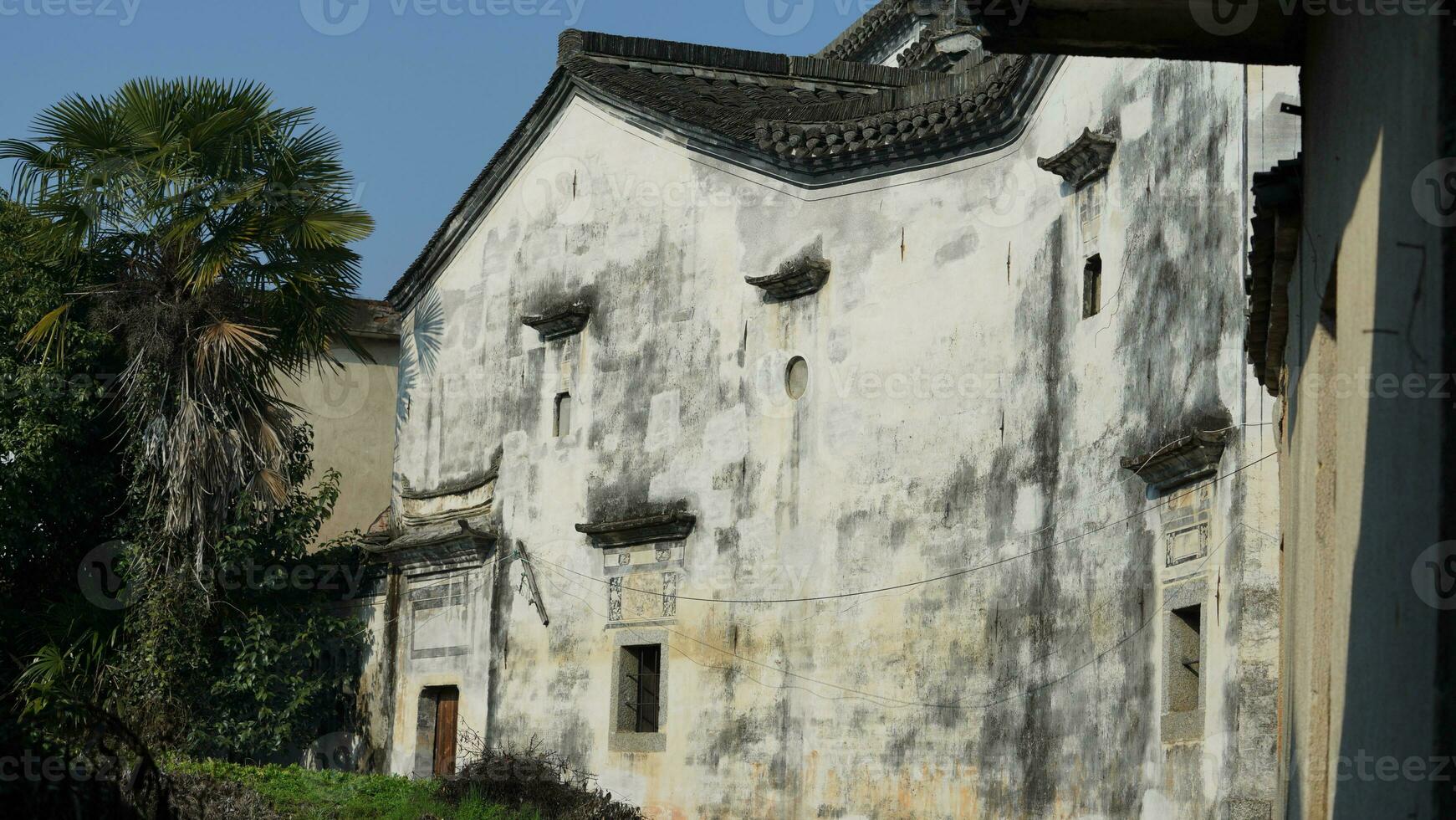The beautiful traditional Chinese village view with the classical architecture and fresh green trees as background photo