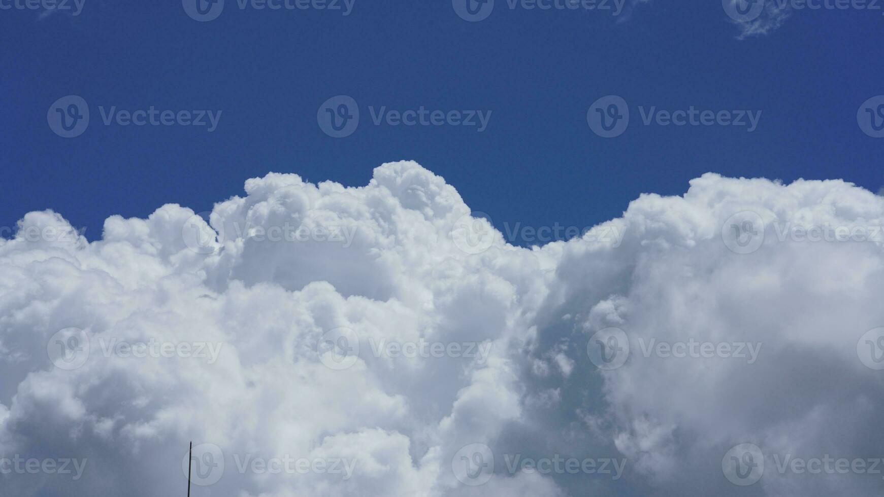 The beautiful sky view with the white clouds and blue sky as background in summer photo