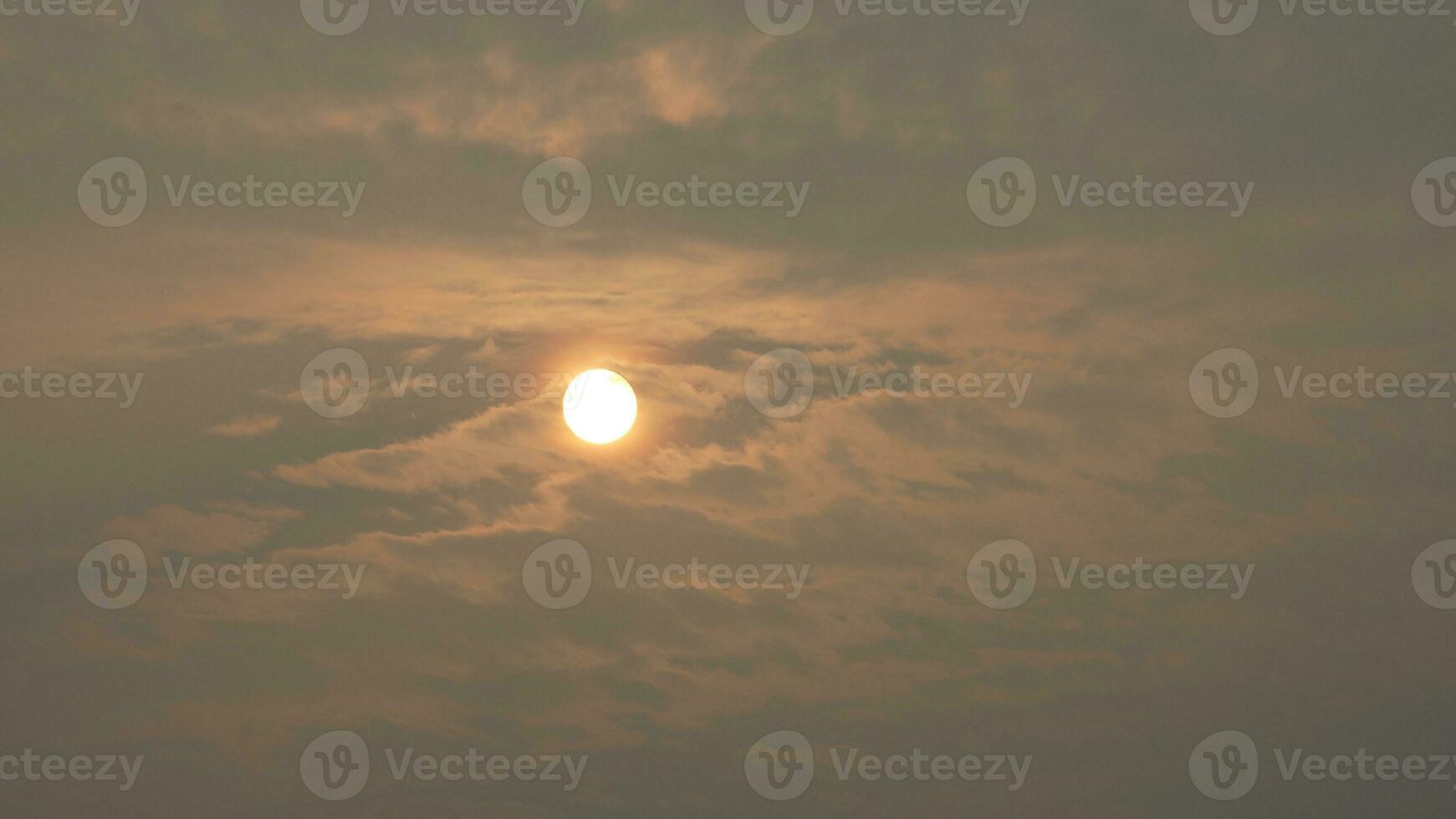 The beautiful sunset view with the buildings' silhouette and orange color sky as background in the city photo