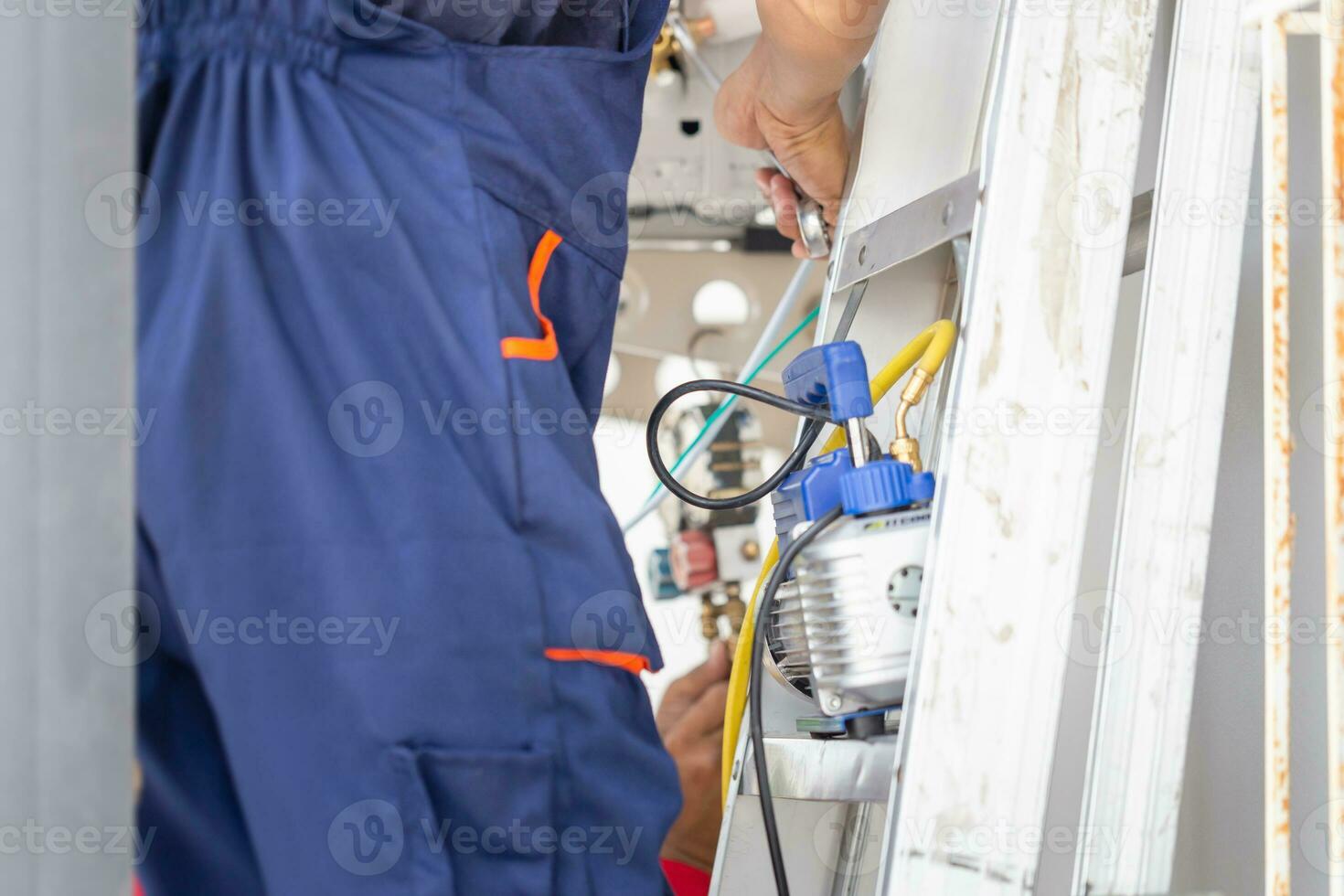 Technician man installing an air conditioning in a client house, Young repairman fixing air conditioner unit, Maintenance and repairing concepts photo