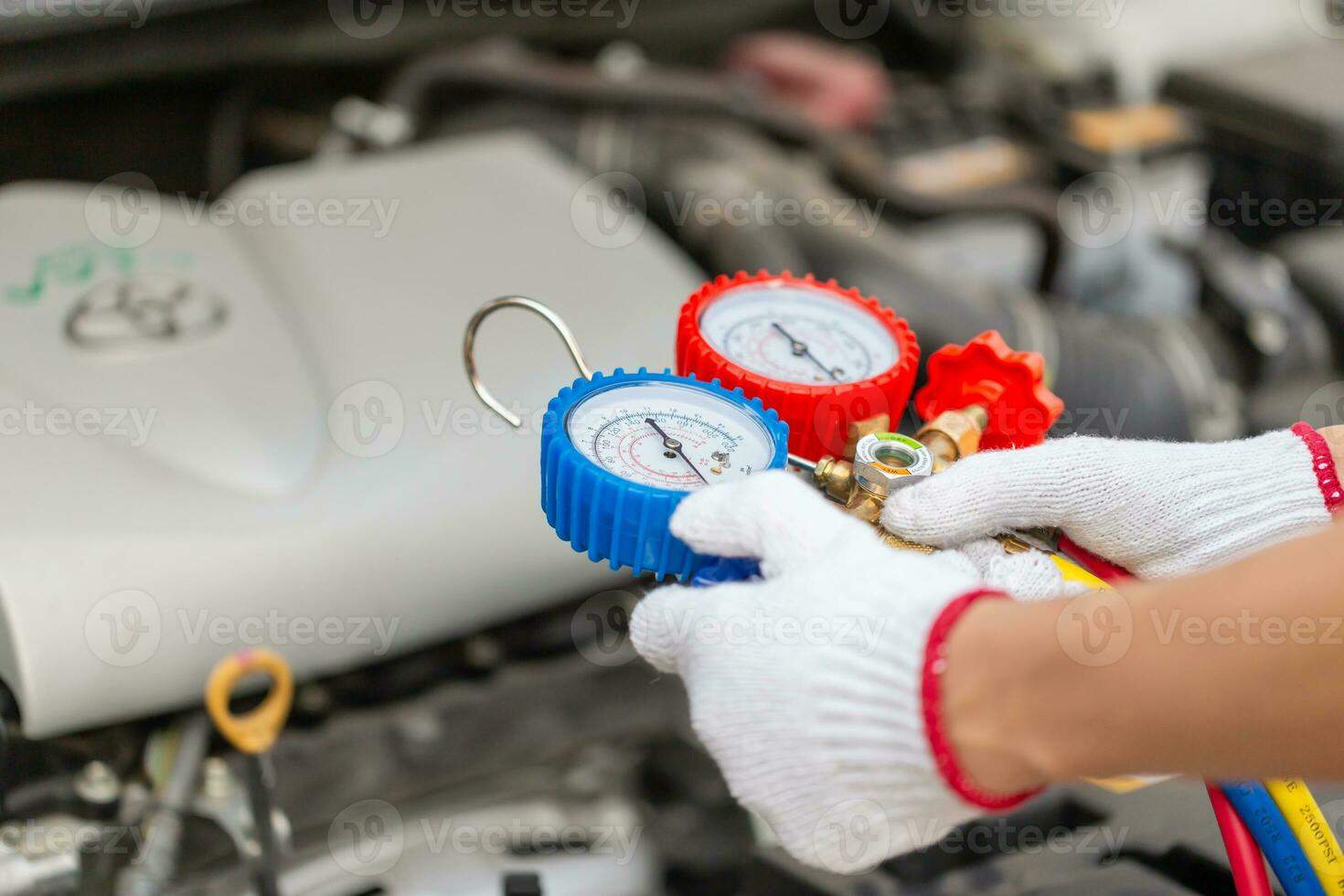 Technician man check car air conditioning system refrigerant recharge, Repairman holding monitor tool to check and fixed car air conditioner system, Air Conditioning Repair photo