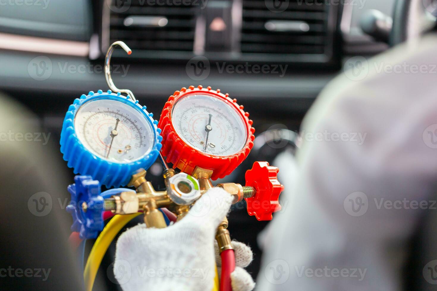 Repairman holding monitor tool to check and fixed car air conditioner system, Technician check car air conditioning system refrigerant recharge, Air Conditioning Repair photo