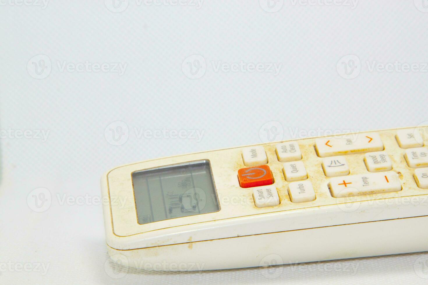 Air conditioner remote control for turning off and on the air conditioner - dirty, dusty. and old can be used normally and control the cold temperature - on a white background photo