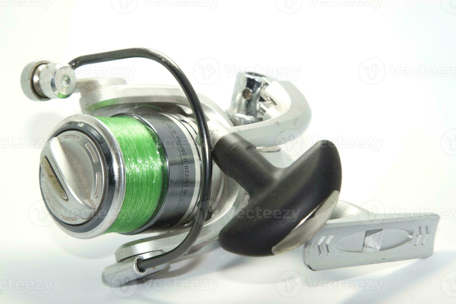 Fishing reels is a leisure sport or hobby of the unemployed, fishing is a popular thing for people to fish to eat and is a sport on a white background. photo