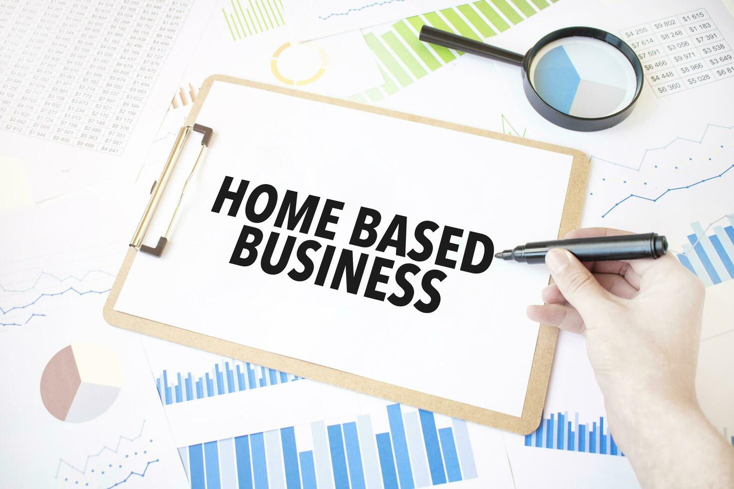 Text home based business on white paper sheet and marker on businessman hand on the diagram. Business concept photo