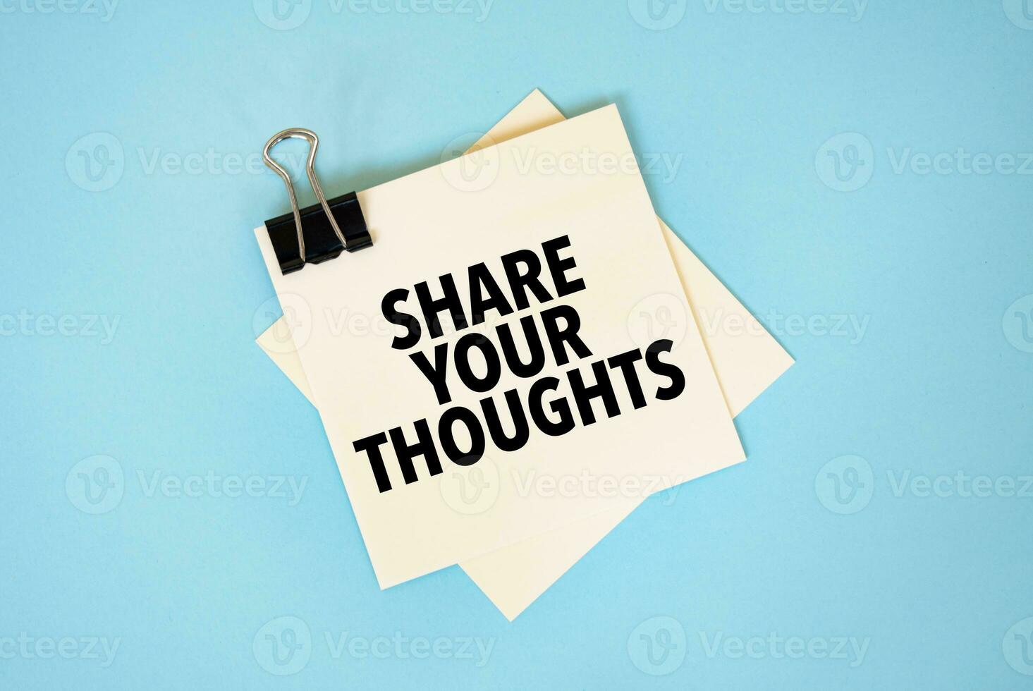 Text SHARE YOUR THOUGHTS on sticky notes with copy space and paper clip