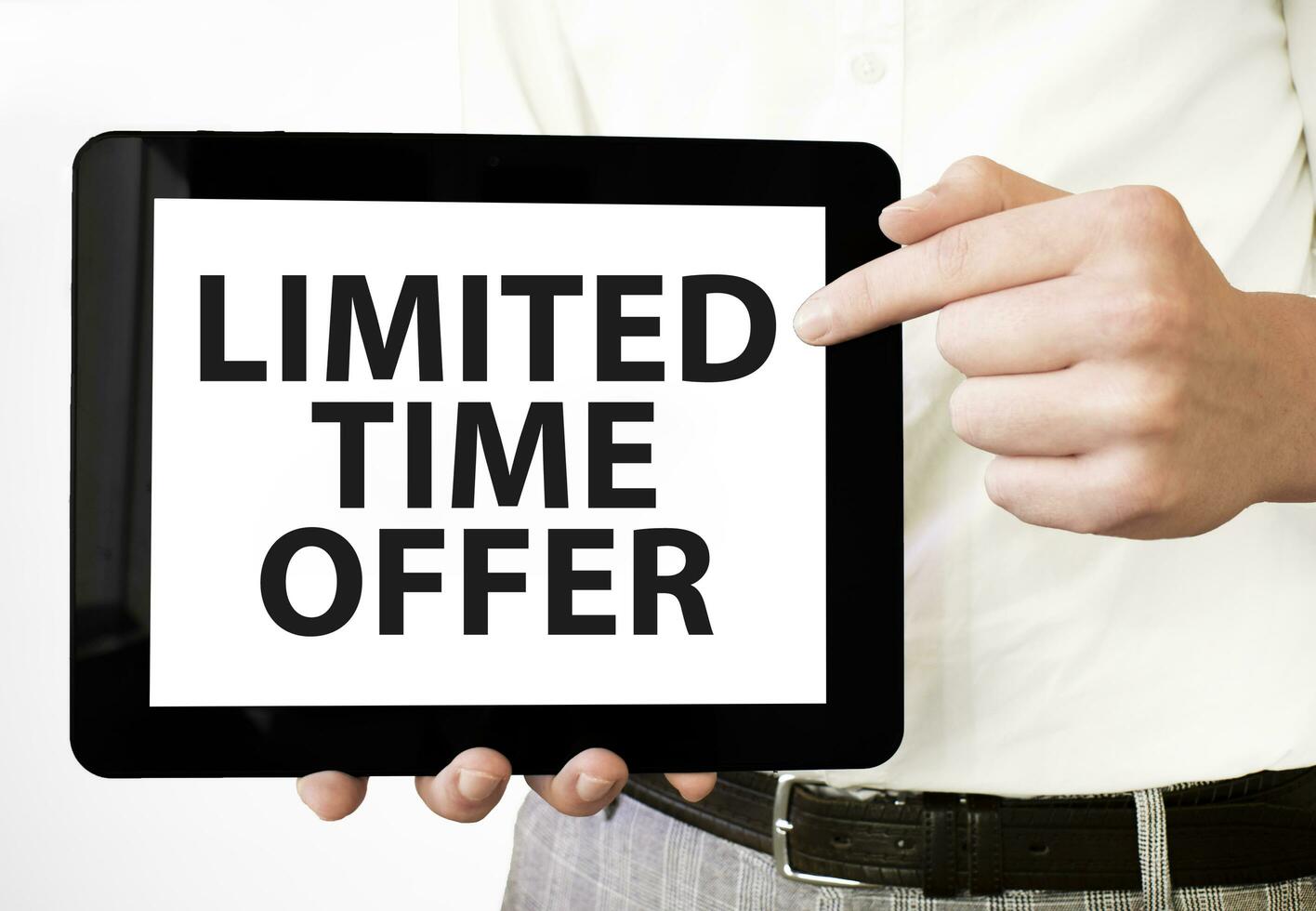 Text LIMITED TIME OFFER on tablet display in businessman hands on the white background. Business concept photo