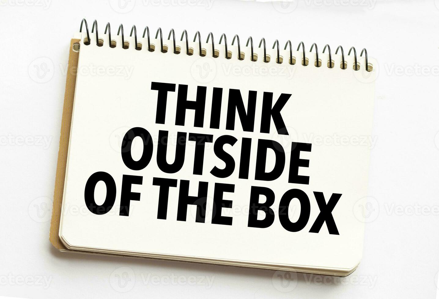 think outside of the box on white notebook photo