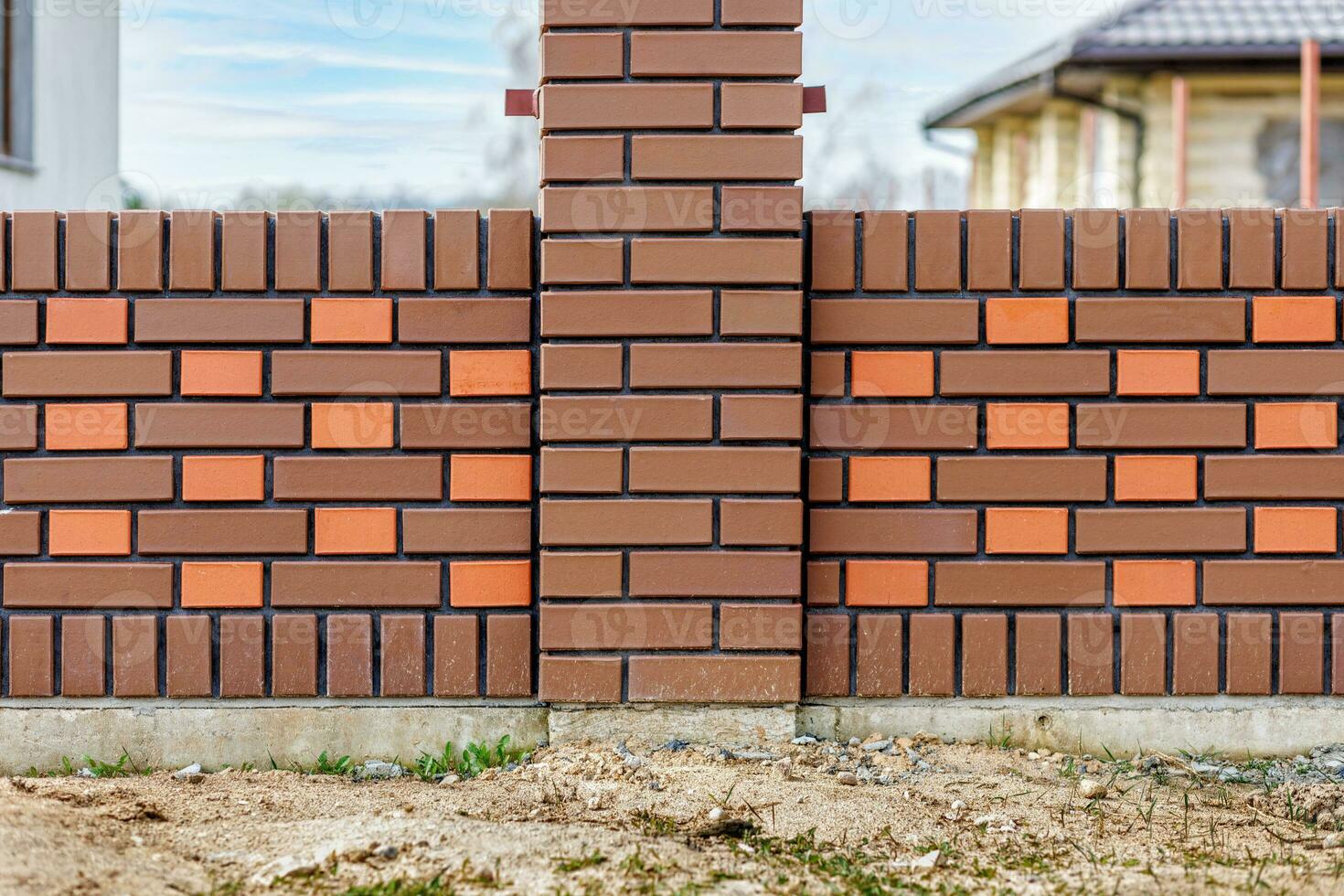 Fragment of a modern fence lined with decorative bricks in the old style photo