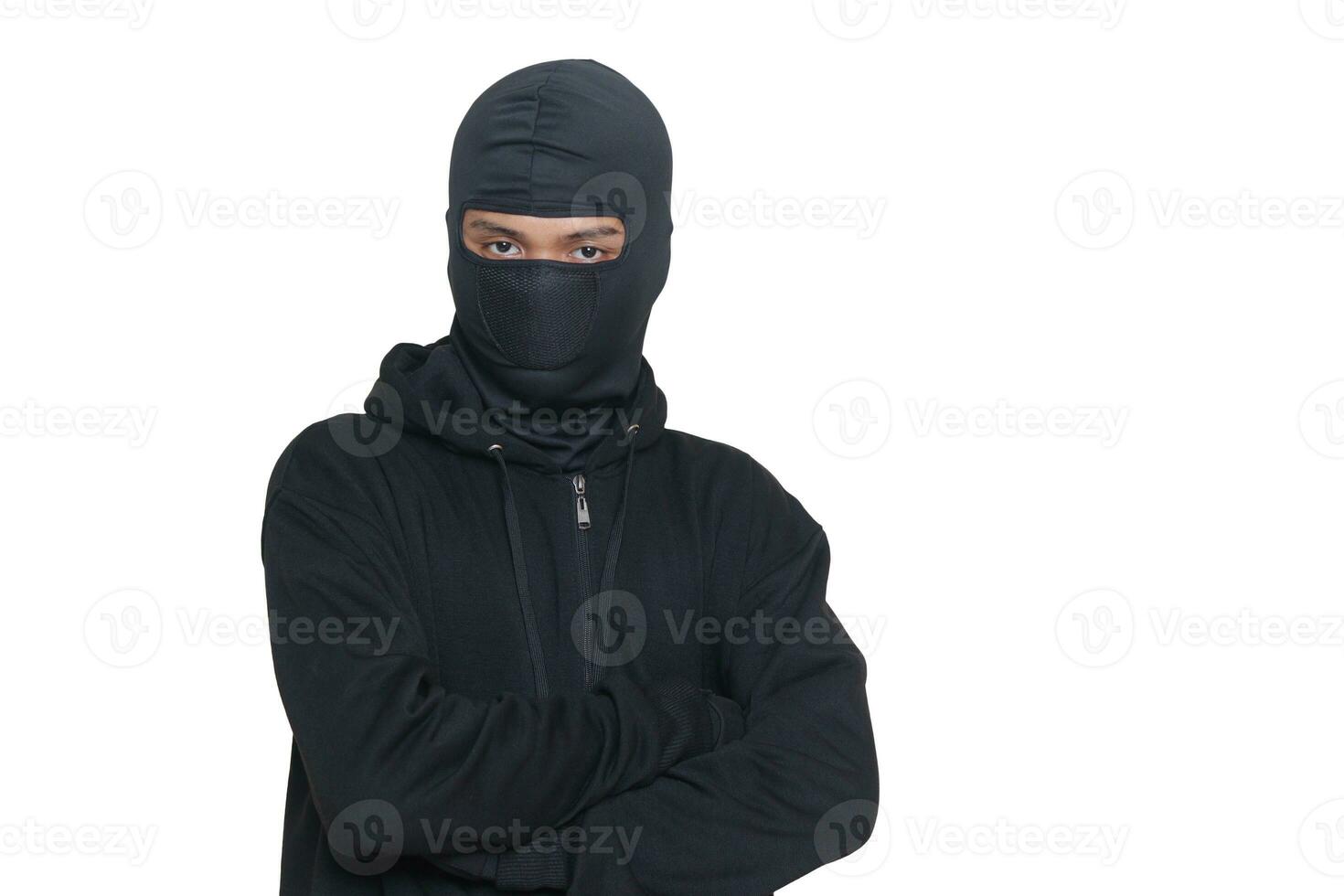 Mysterious man wearing black hoodie standing and looking at camera. Isolated image on gray background photo