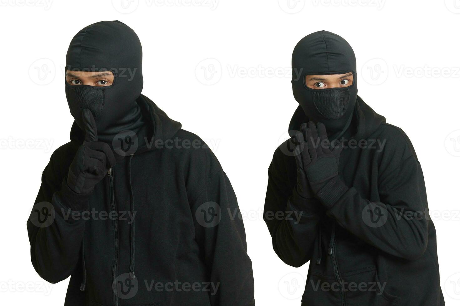 Mysterious man wearing black hoodie standing and looking at camera. Isolated image on gray background photo