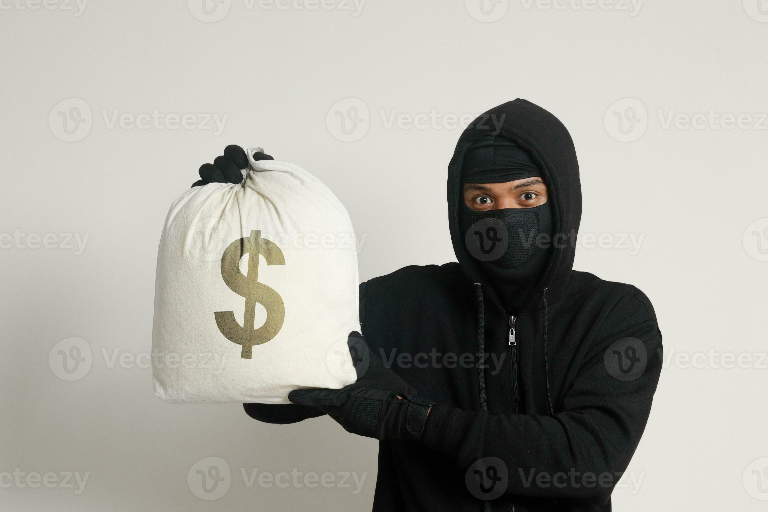Mysterious robber thief man wearing black hoodie and mask
